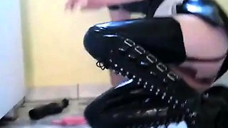 Latex-clad brunette maid's solo kitchen play.