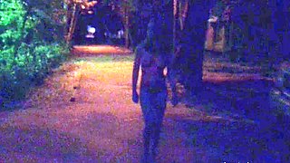 Naked woman walking on the city street in the early