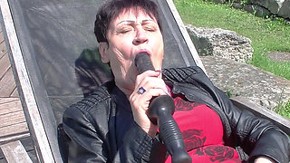 Granny enjoys dildo in garden