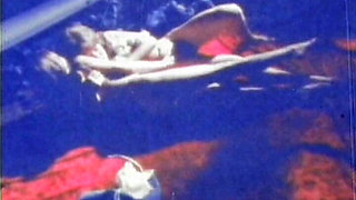 Blue-tinted Vintage Loop Shows Retro Couple in Raw 70s Action