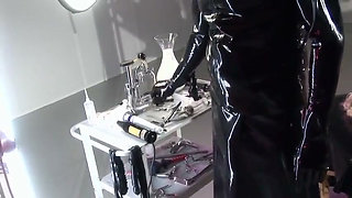 Busty submissive gets pissed on and fucked by latex maledoms