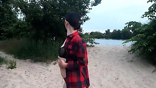 Brunette amateur with small tits shows pussy on public beach