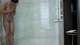 Small titted teen masturbates in shower